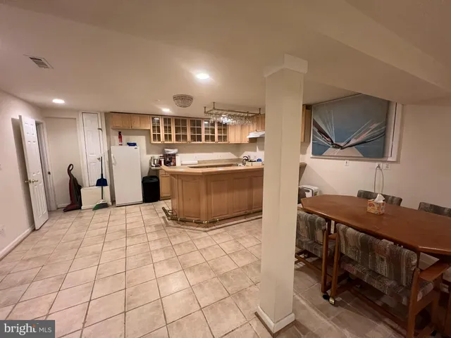 a kitchen with kitchen island a sink stove and refrigerator