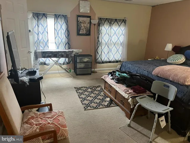 a bedroom with furniture and a window