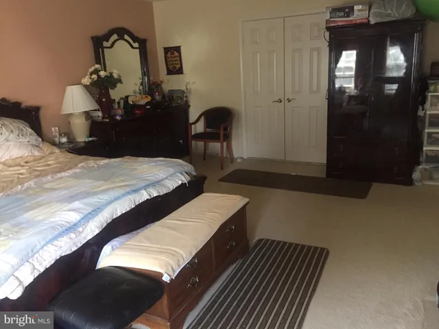 a bedroom with a bed and a mirror