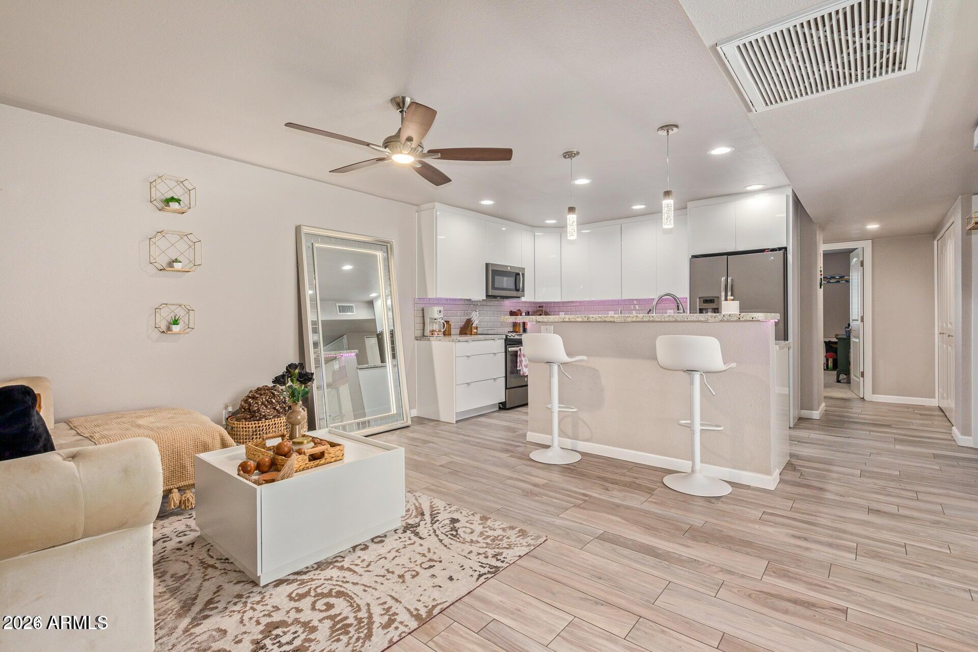 5913 East Thomas Road Scottsdale, AZ 85251 - Photo 7 of 26 a living room with furniture and kitchen view