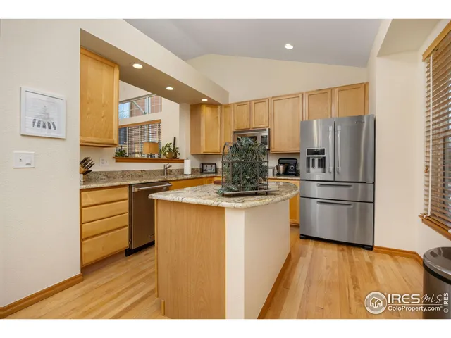 a kitchen with stainless steel appliances a refrigerator a sink a stove and cabinets