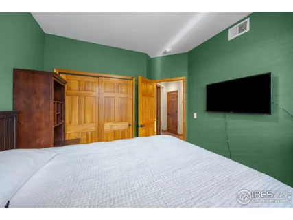 a view of an empty room with a flat screen tv and a fireplace