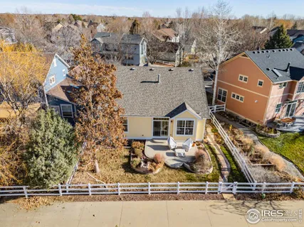an aerial view of house with yard and ocean view