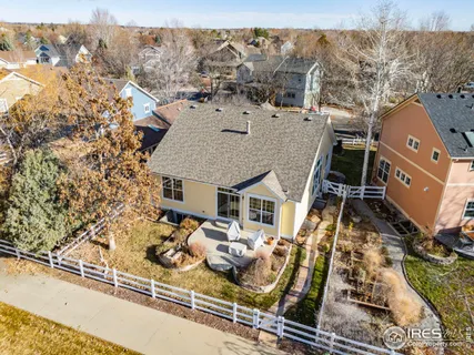 an aerial view of a house with a yard