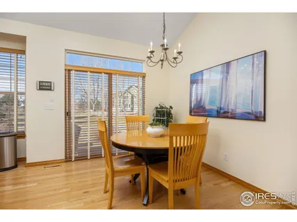a view of a dining room with furniture a chandelier and wooden floor