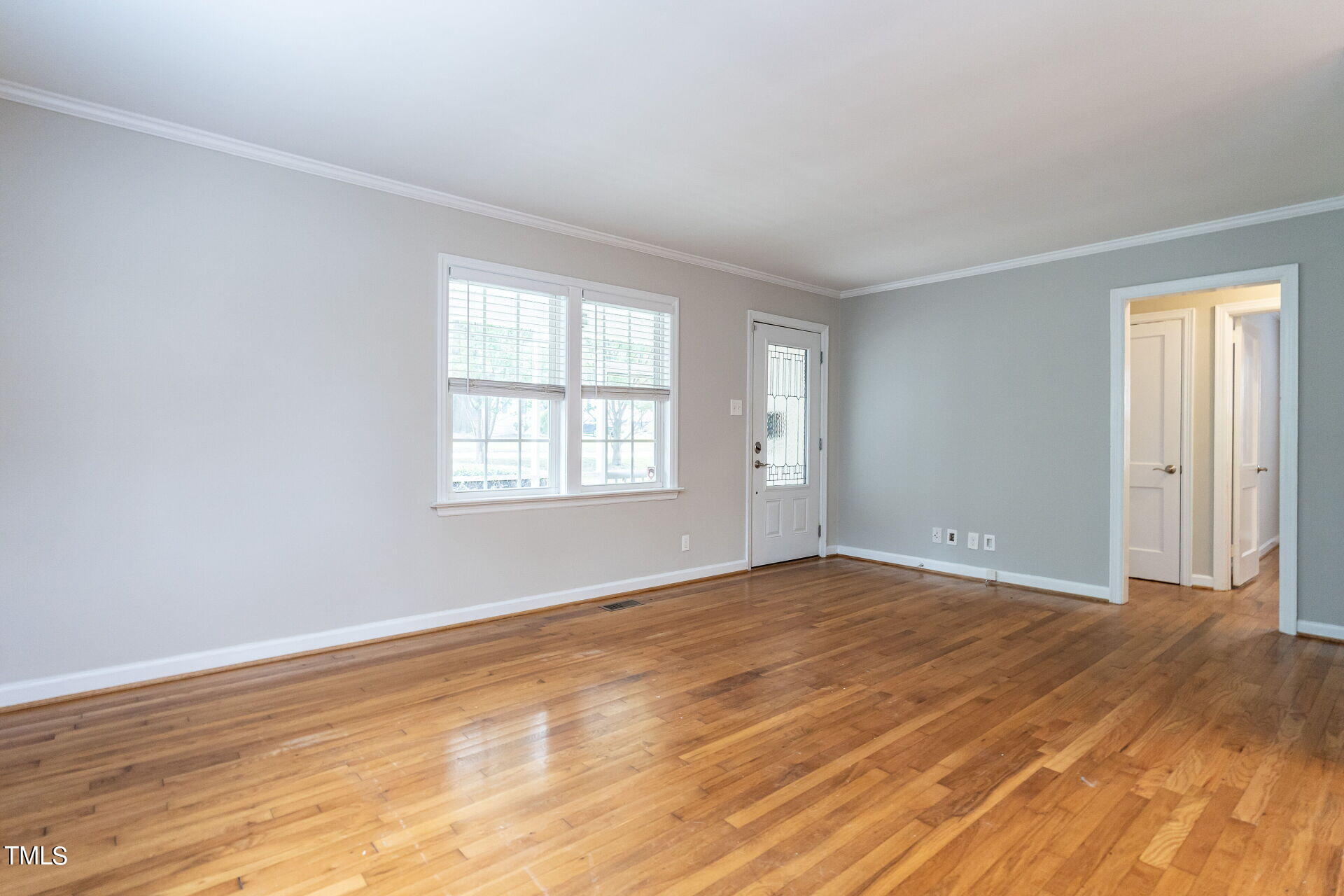 116 Plainview Avenue Raleigh, NC 27604 - Photo 14 of 35 a view of an empty room with wooden floor and a window