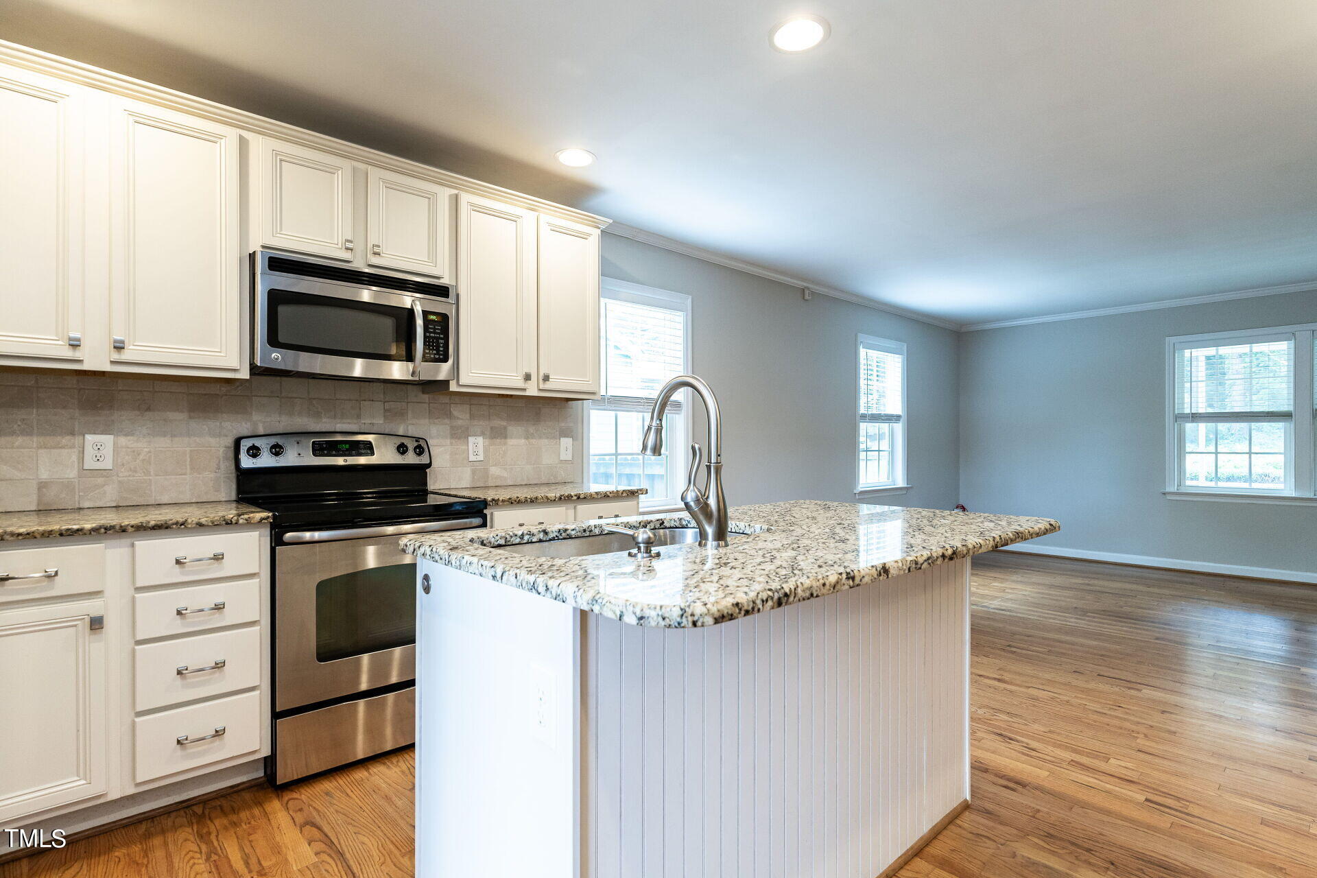 116 Plainview Avenue Raleigh, NC 27604 - Photo 17 of 35 a kitchen with stainless steel appliances granite countertop a sink a stove a microwave and cabinets