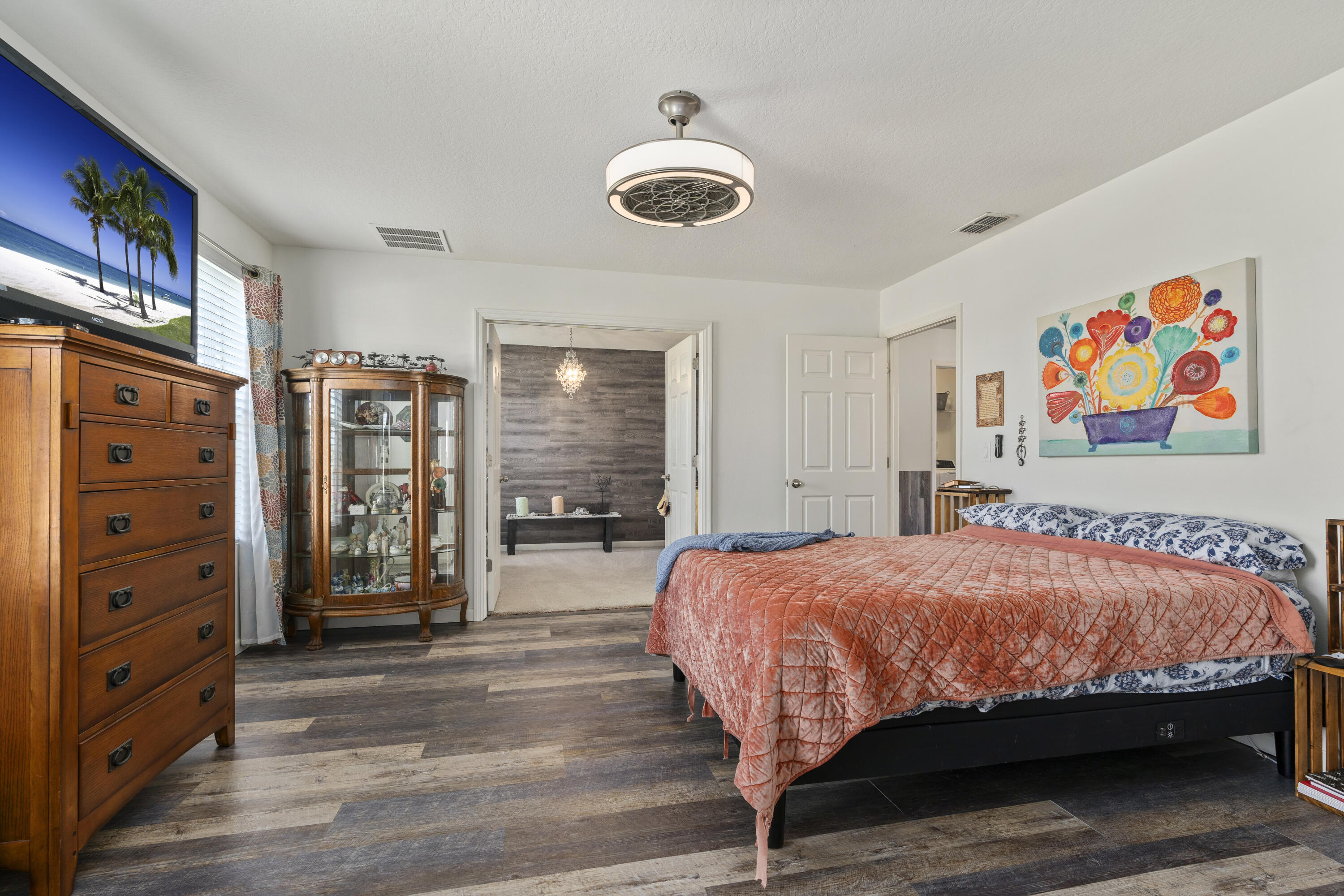 3100 Yellowstone Circle Fort Pierce, FL 34945 - Photo 18 of 28 a bedroom with a bed and a chandelier