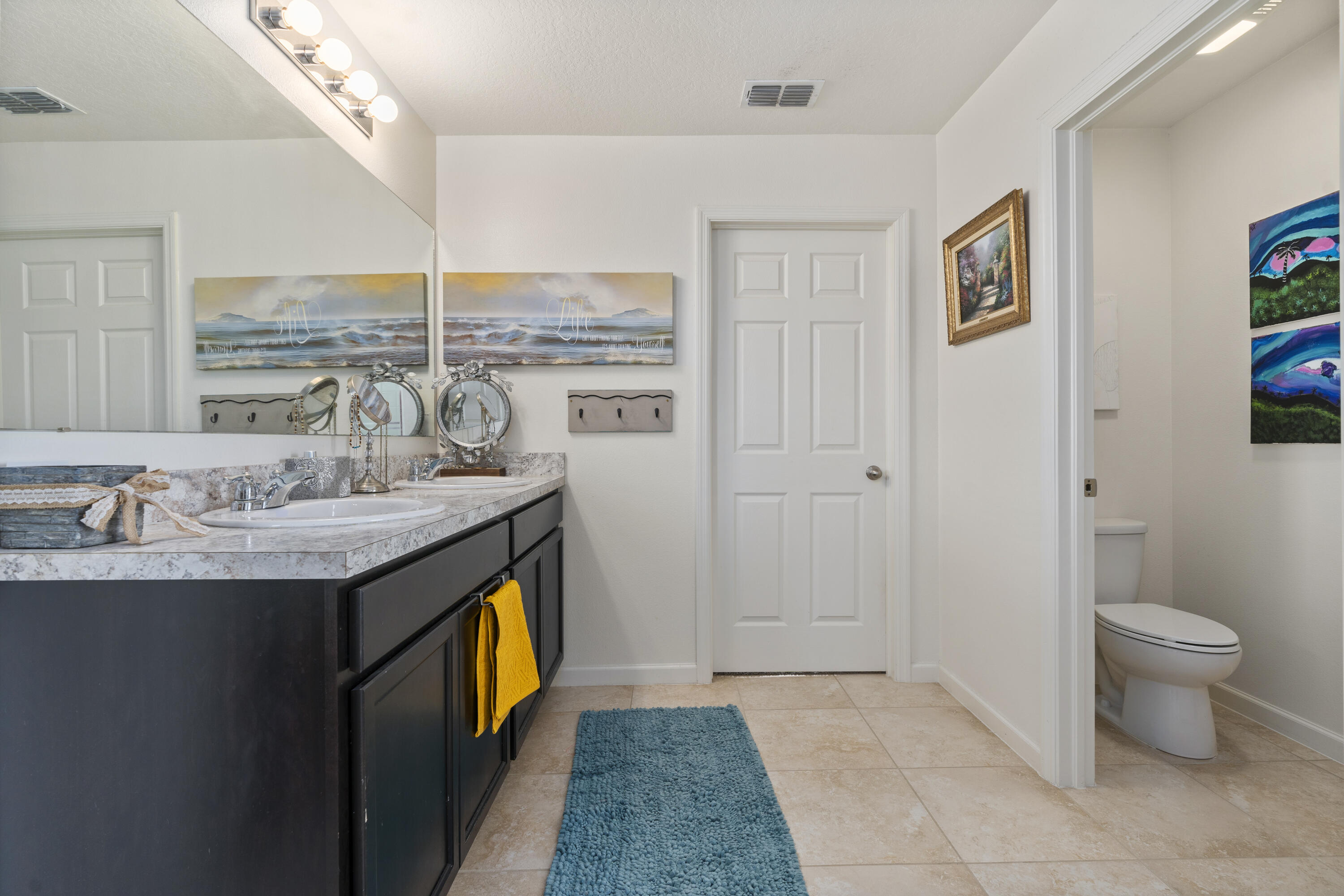 3100 Yellowstone Circle Fort Pierce, FL 34945 - Photo 20 of 28 a bathroom with a granite countertop sink a toilet and a mirror