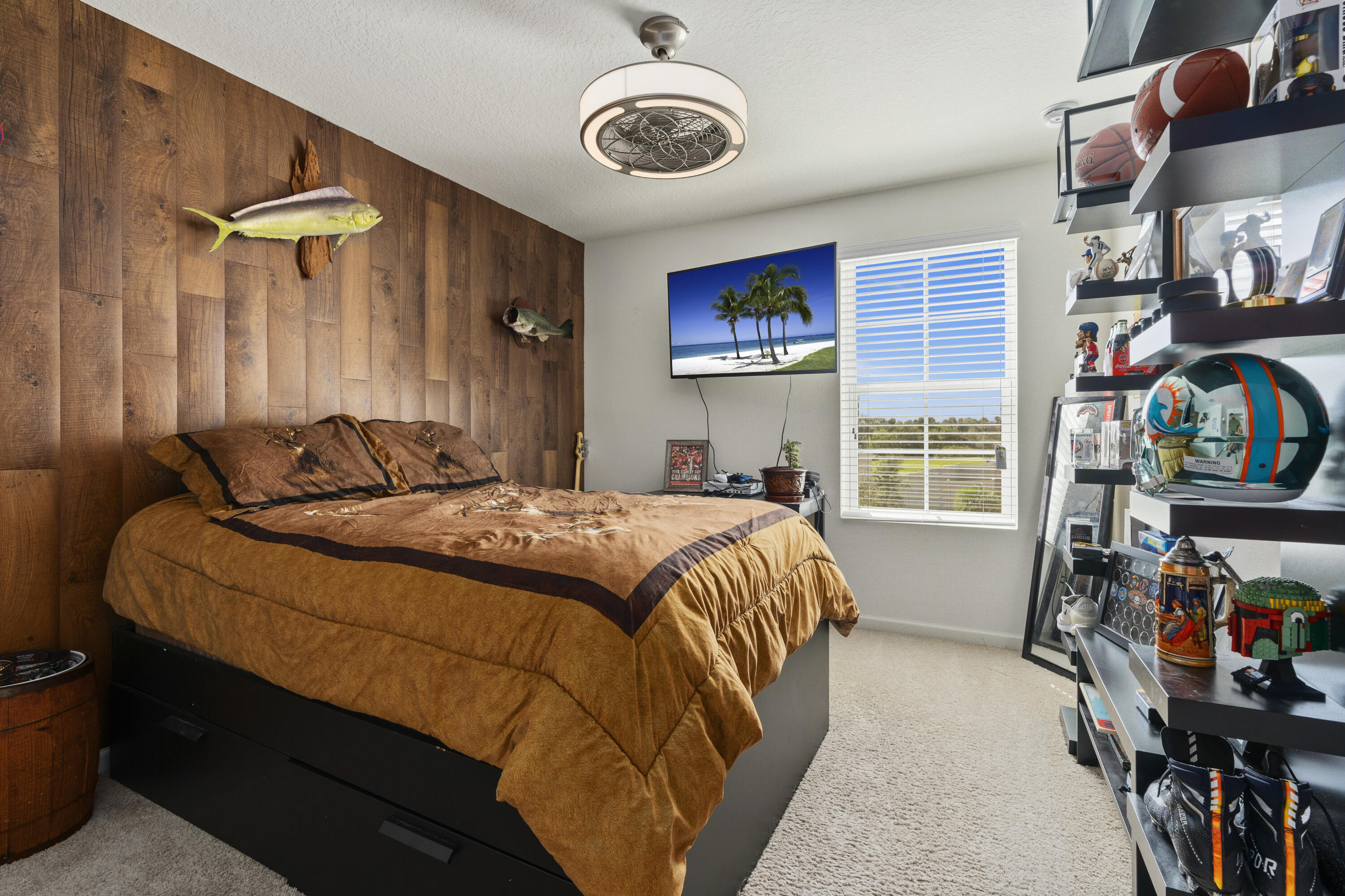 3100 Yellowstone Circle Fort Pierce, FL 34945 - Photo 24 of 28 a bed sitting in a bedroom next to a window and a chandelier