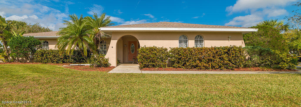 700 Montclair Road Northeast Palm Bay, FL 32905 - Photo 1 of 46 a front view of a house with garden