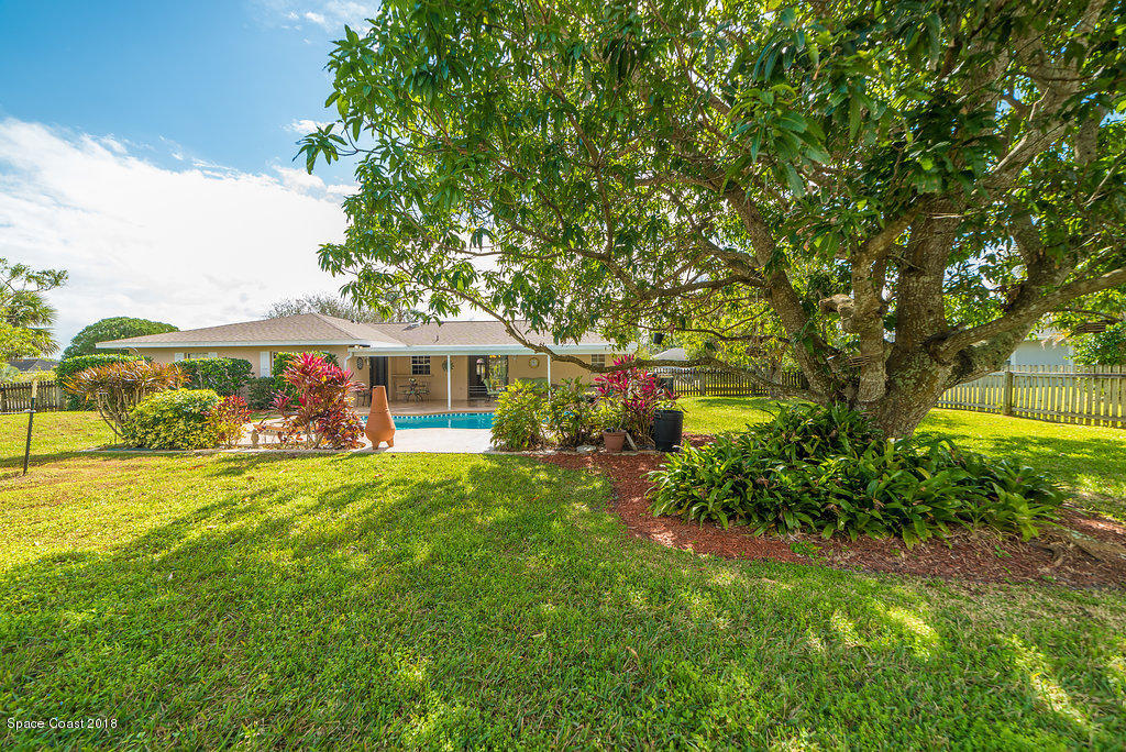700 Montclair Road Northeast Palm Bay, FL 32905 - Photo 13 of 46 a front view of a house with garden