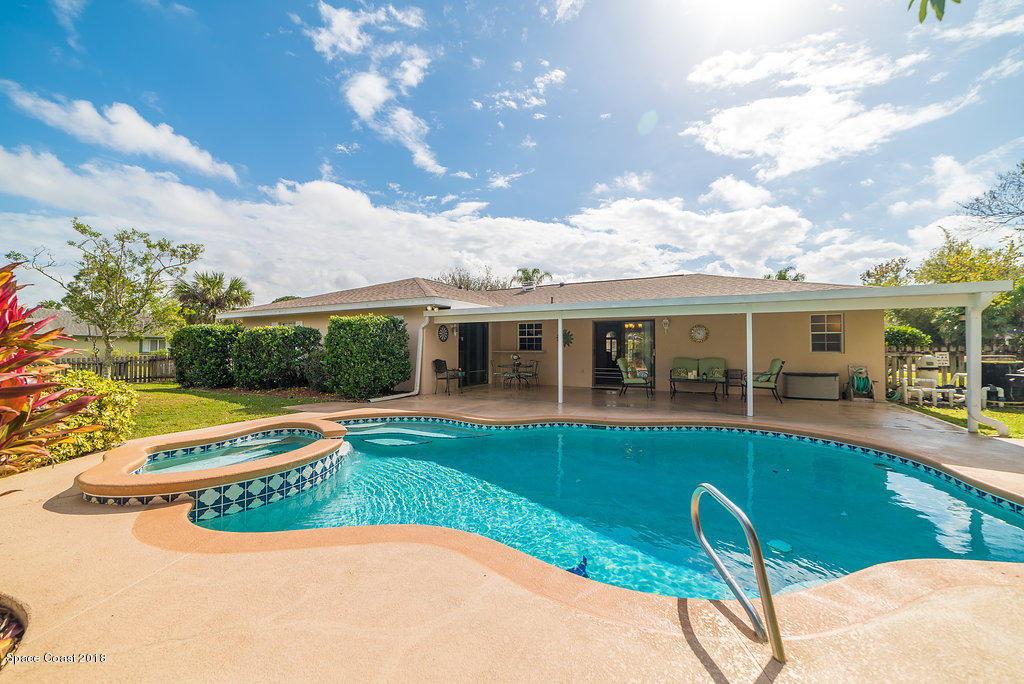 700 Montclair Road Northeast Palm Bay, FL 32905 - Photo 17 of 46 a view of a house with backyard porch and sitting area