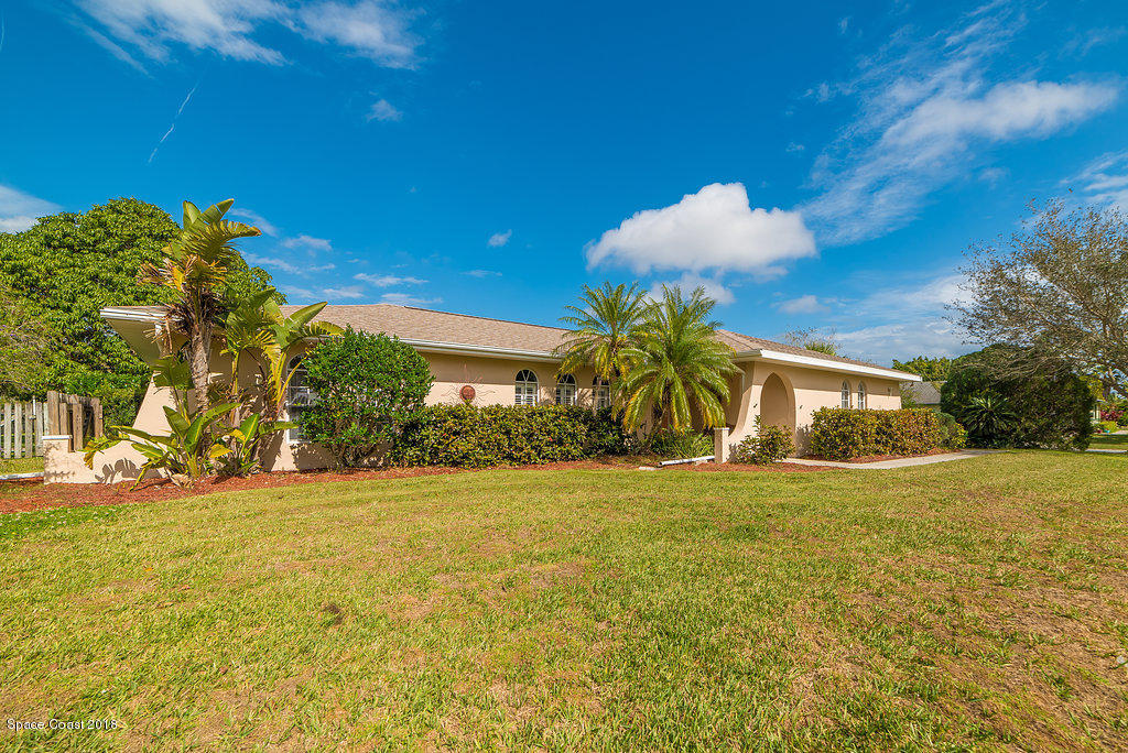 700 Montclair Road Northeast Palm Bay, FL 32905 - Photo 3 of 46 a front view of a house with a yard