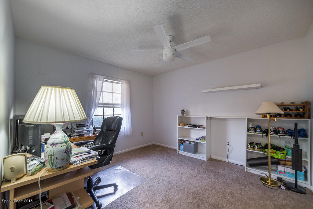 700 Montclair Road Northeast Palm Bay, FL 32905 - Photo 21 of 46 a view of a workspace with furniture and a window