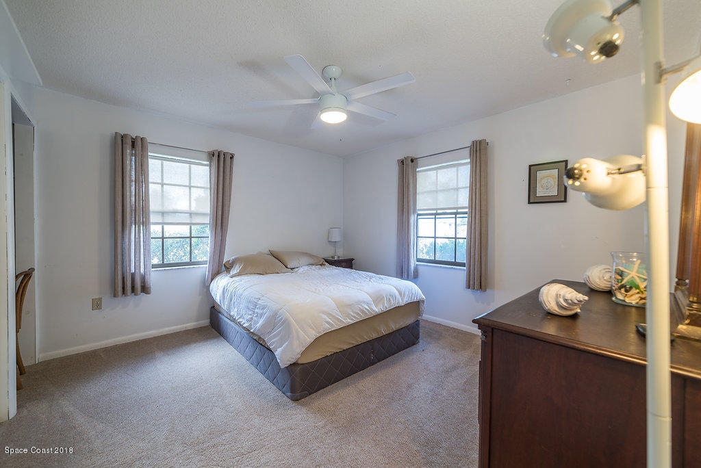 700 Montclair Road Northeast Palm Bay, FL 32905 - Photo 23 of 46 a bedroom with a bed and window