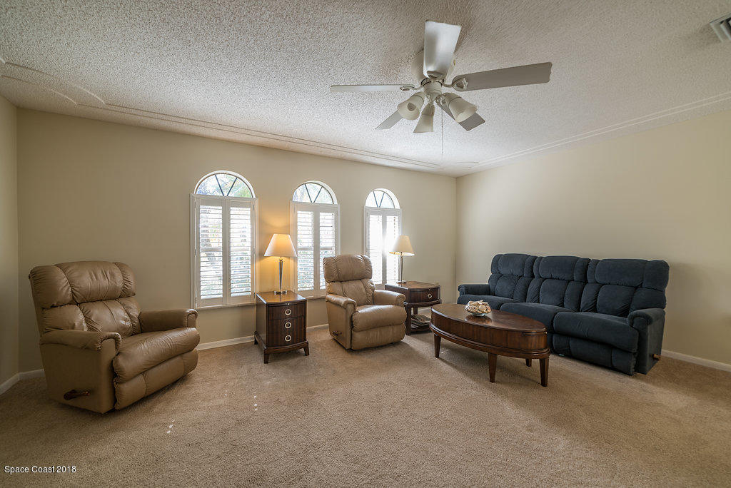 700 Montclair Road Northeast Palm Bay, FL 32905 - Photo 25 of 46 a living room with furniture and a large window