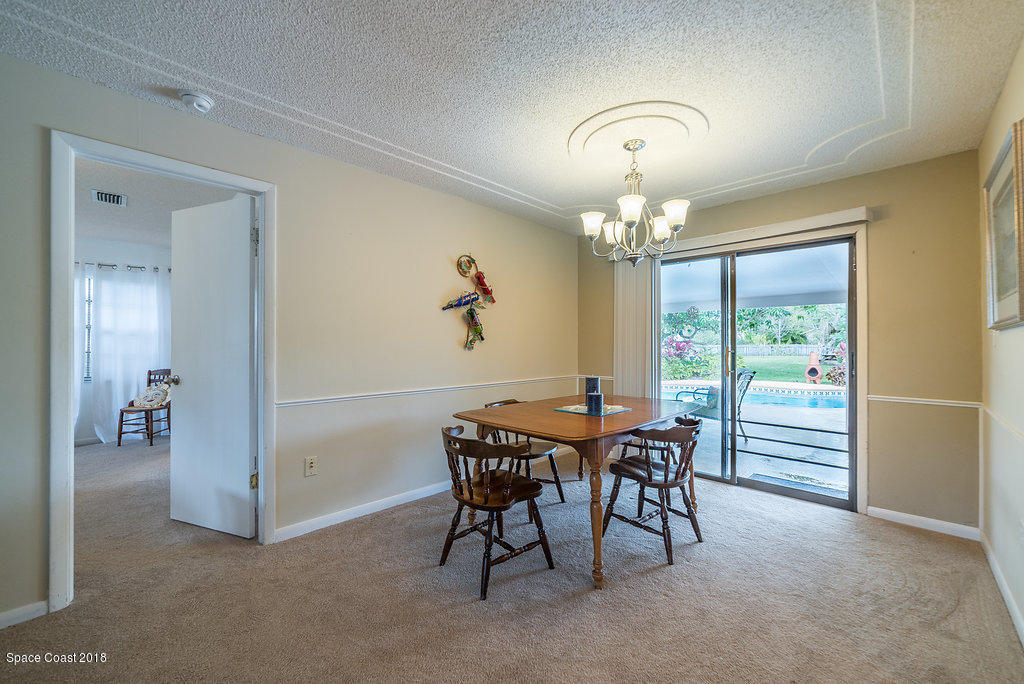 700 Montclair Road Northeast Palm Bay, FL 32905 - Photo 26 of 46 a view of a dining room with furniture window and outside view