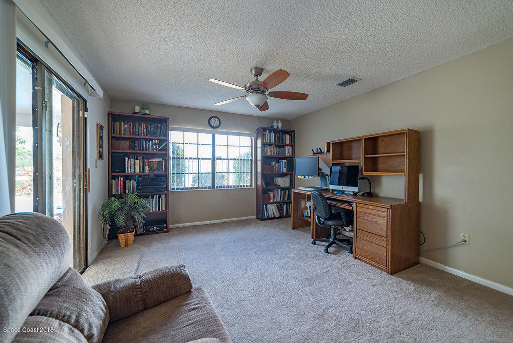 700 Montclair Road Northeast Palm Bay, FL 32905 - Photo 28 of 46 a living room with furniture and a window