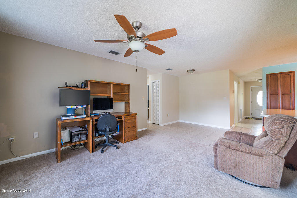 700 Montclair Road Northeast Palm Bay, FL 32905 - Photo 30 of 46 a view of a livingroom with workspace and a window