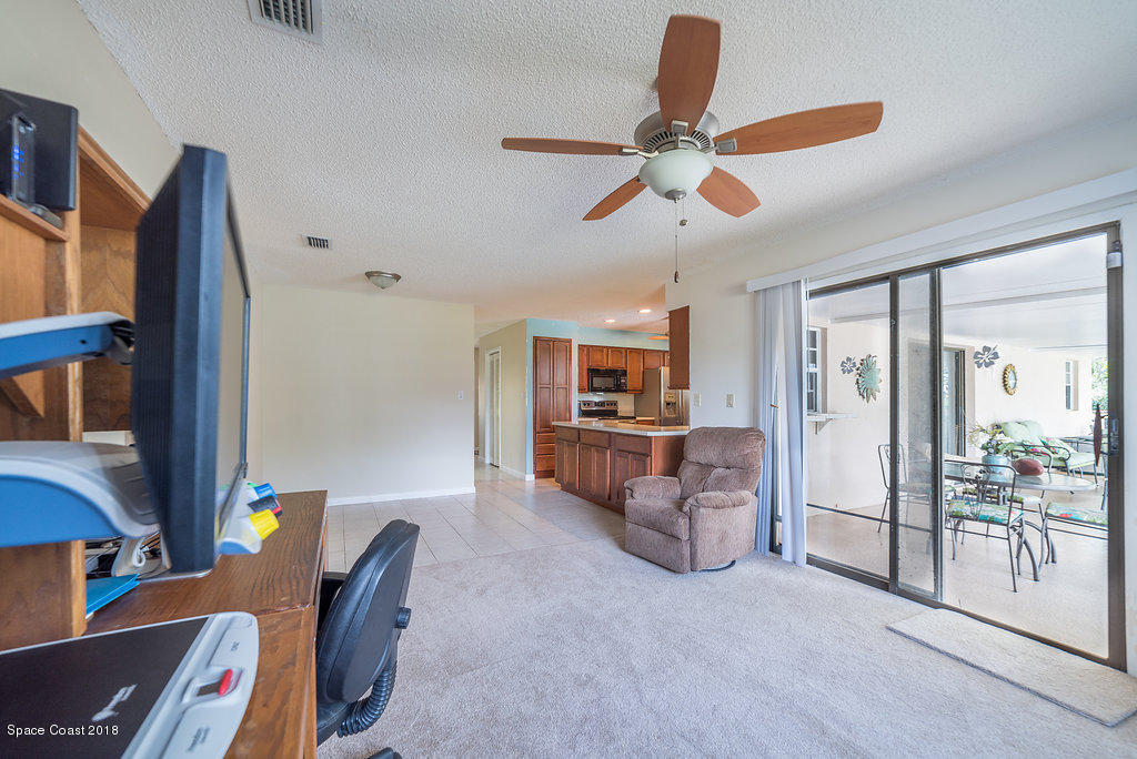700 Montclair Road Northeast Palm Bay, FL 32905 - Photo 31 of 46 a living room with furniture and a window