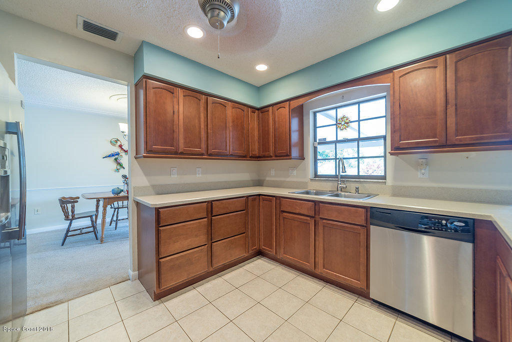 700 Montclair Road Northeast Palm Bay, FL 32905 - Photo 33 of 46 a kitchen with cabinets and window
