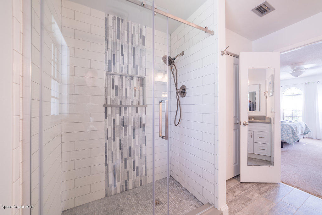 700 Montclair Road Northeast Palm Bay, FL 32905 - Photo 38 of 46 a bathroom with a shower and a glass door