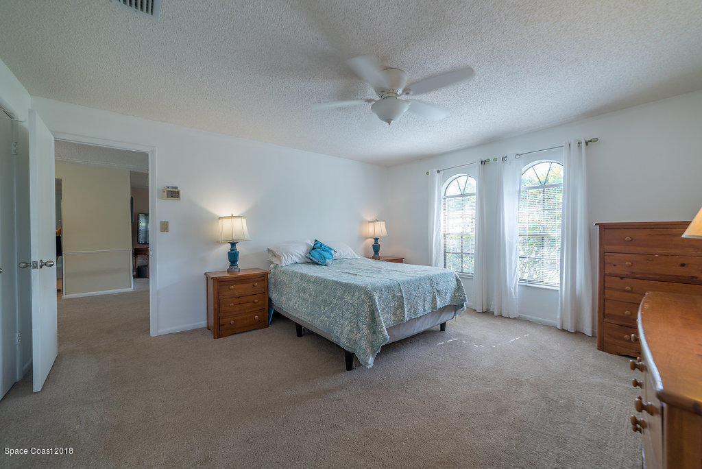 700 Montclair Road Northeast Palm Bay, FL 32905 - Photo 42 of 46 a bedroom with a bed closet and a window