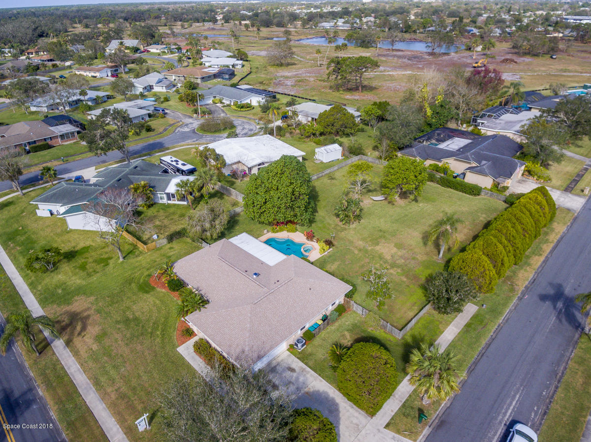 700 Montclair Road Northeast Palm Bay, FL 32905 - Photo 44 of 46 an aerial view of residential houses with outdoor space