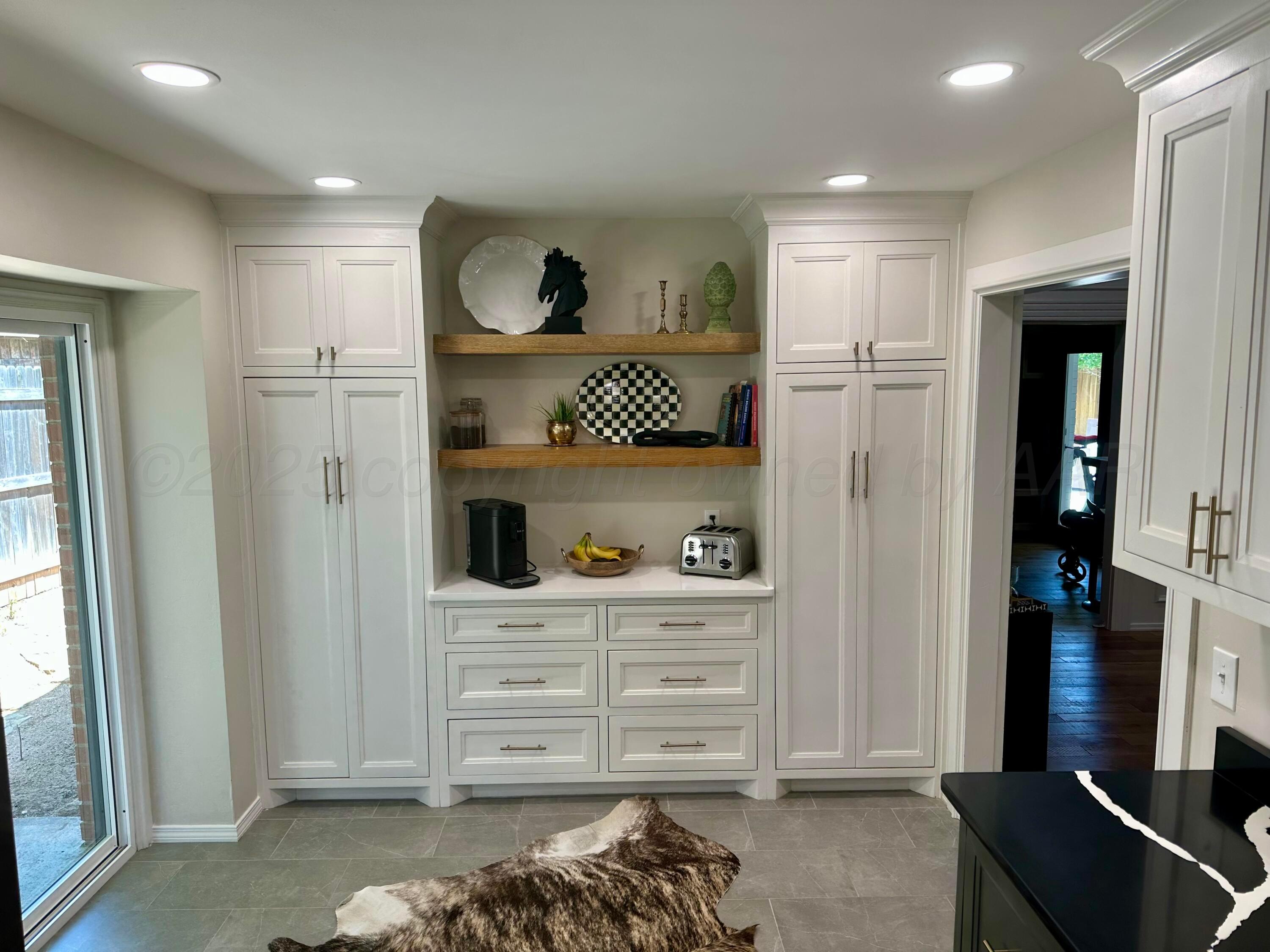 7714 Baughman Drive Amarillo, TX 79121 - Photo 14 of 37 a kitchen with a refrigerator and cabinets