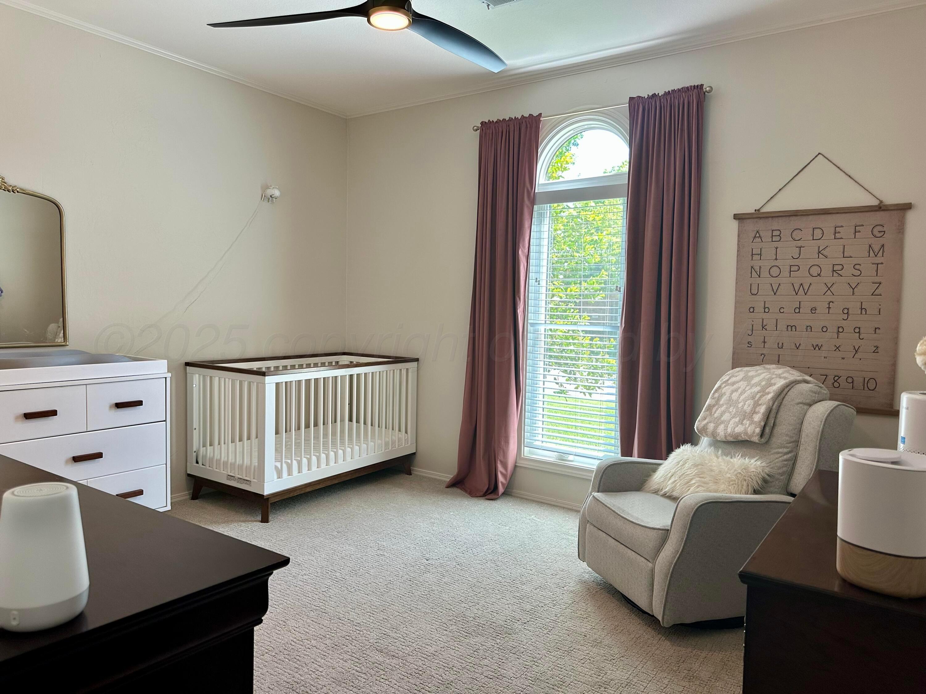 7714 Baughman Drive Amarillo, TX 79121 - Photo 24 of 37 a bedroom with a bed and a window