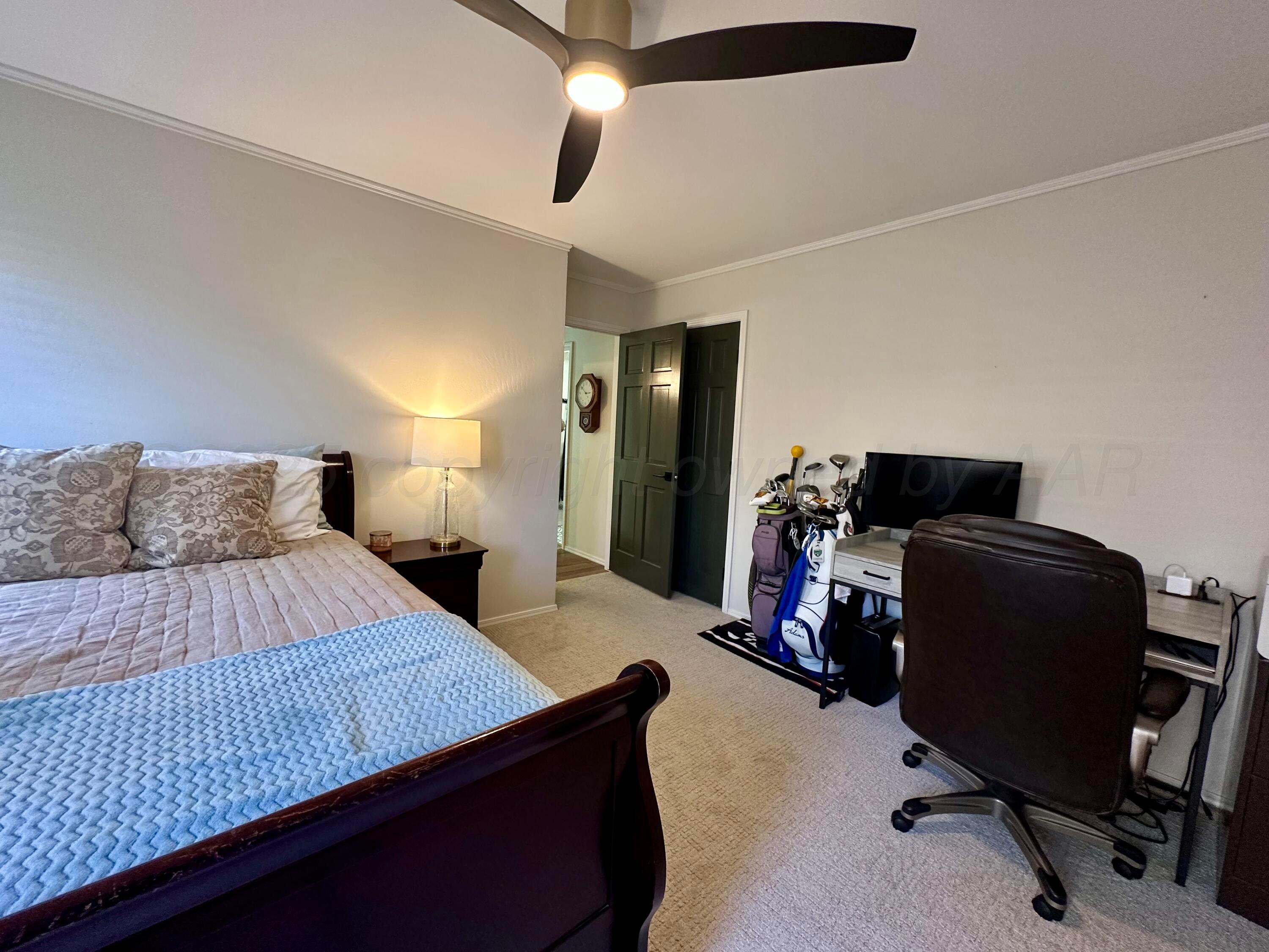 7714 Baughman Drive Amarillo, TX 79121 - Photo 29 of 37 a bedroom with a bed and a chair