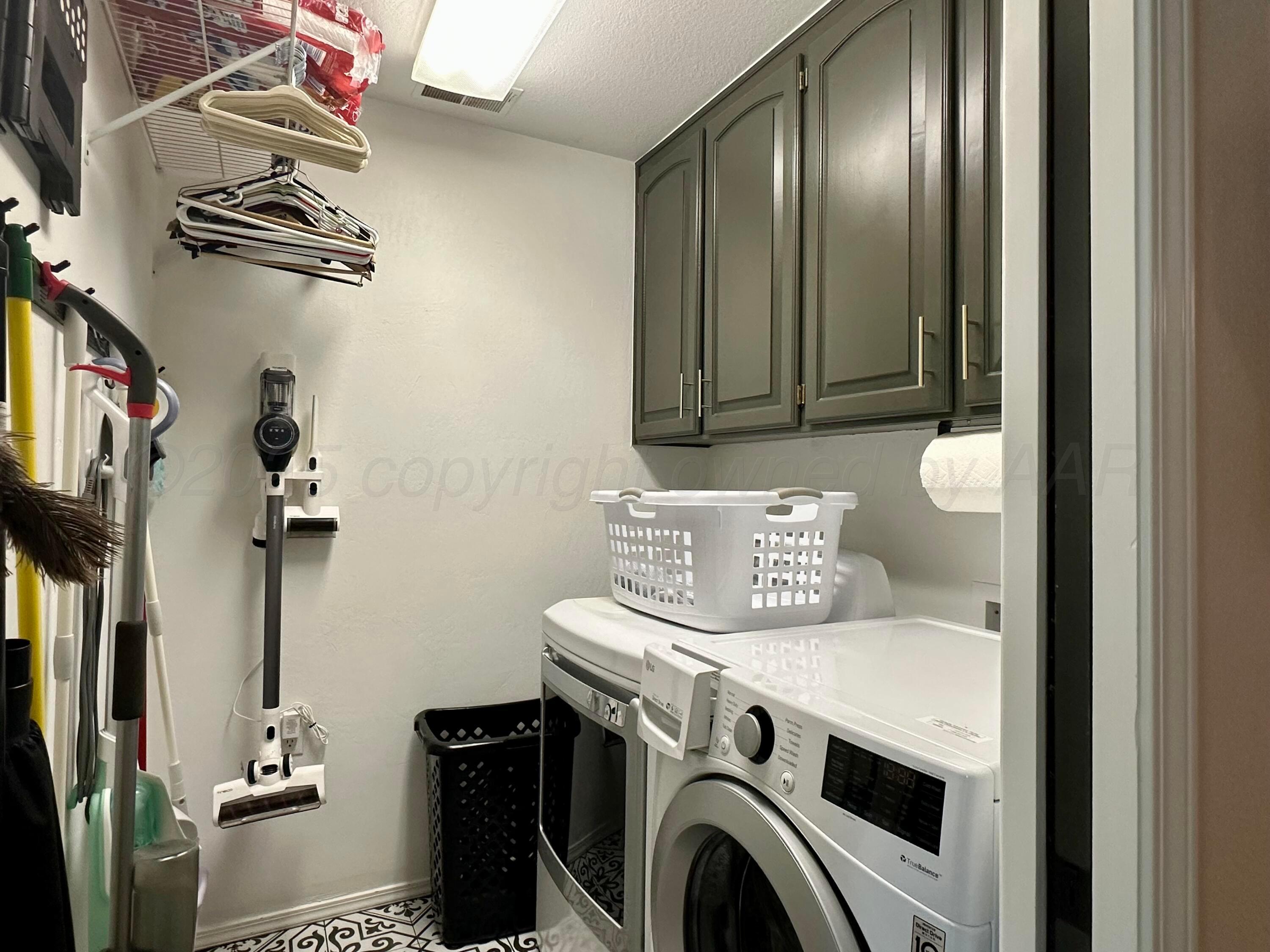 7714 Baughman Drive Amarillo, TX 79121 - Photo 30 of 37 a view of washer and dryer with bathroom in the background