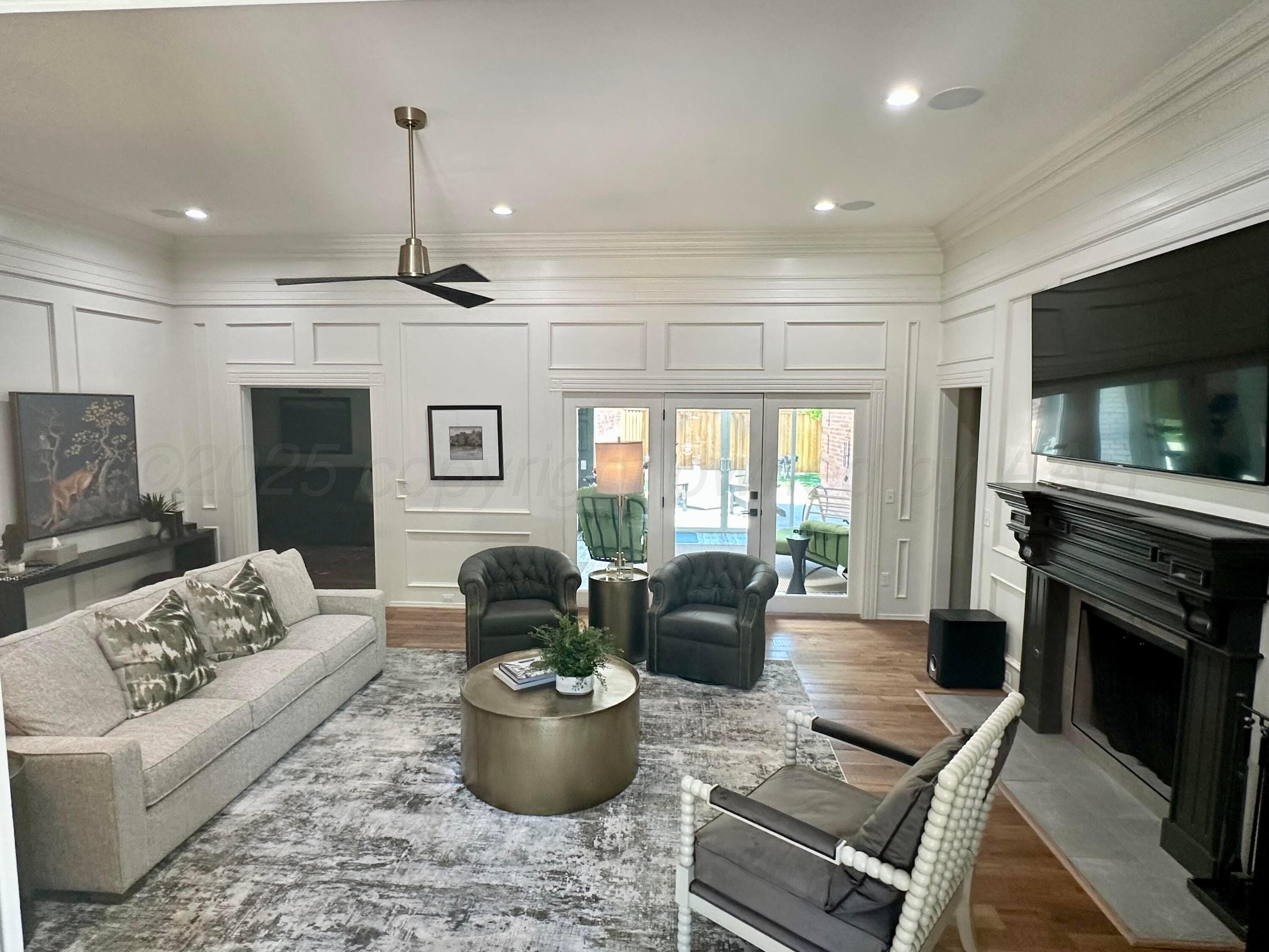 7714 Baughman Drive Amarillo, TX 79121 - Photo 3 of 37 a living room with furniture a flat screen tv and a fireplace