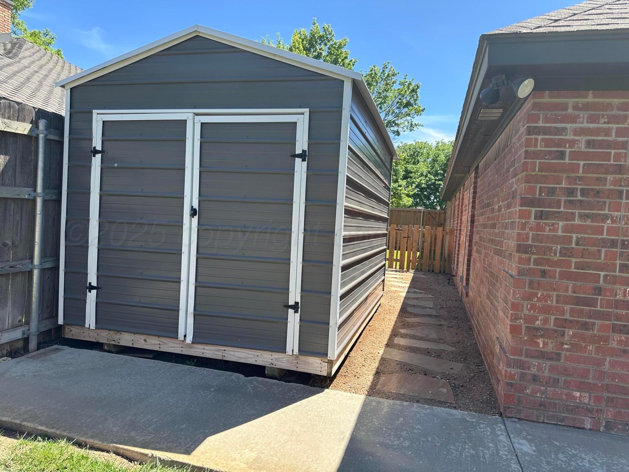 7714 Baughman Drive Amarillo, TX 79121 - Photo 31 of 37 a view of a wooden door with a house