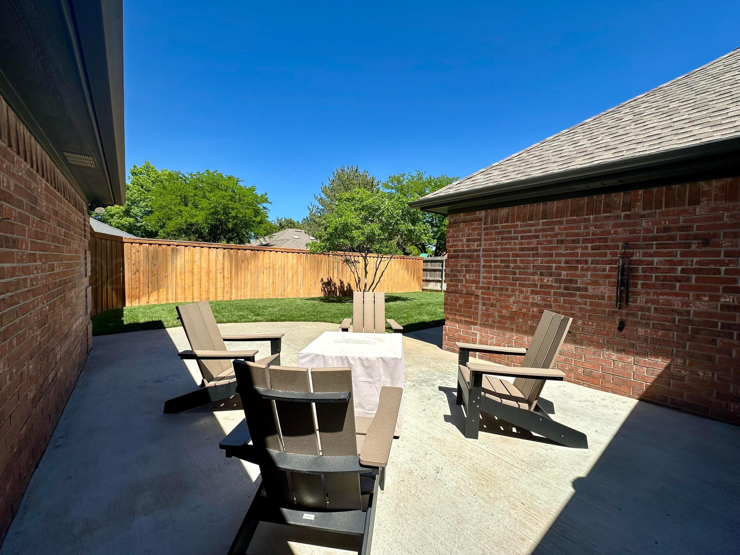 7714 Baughman Drive Amarillo, TX 79121 - Photo 35 of 37 a patio with table and chairs