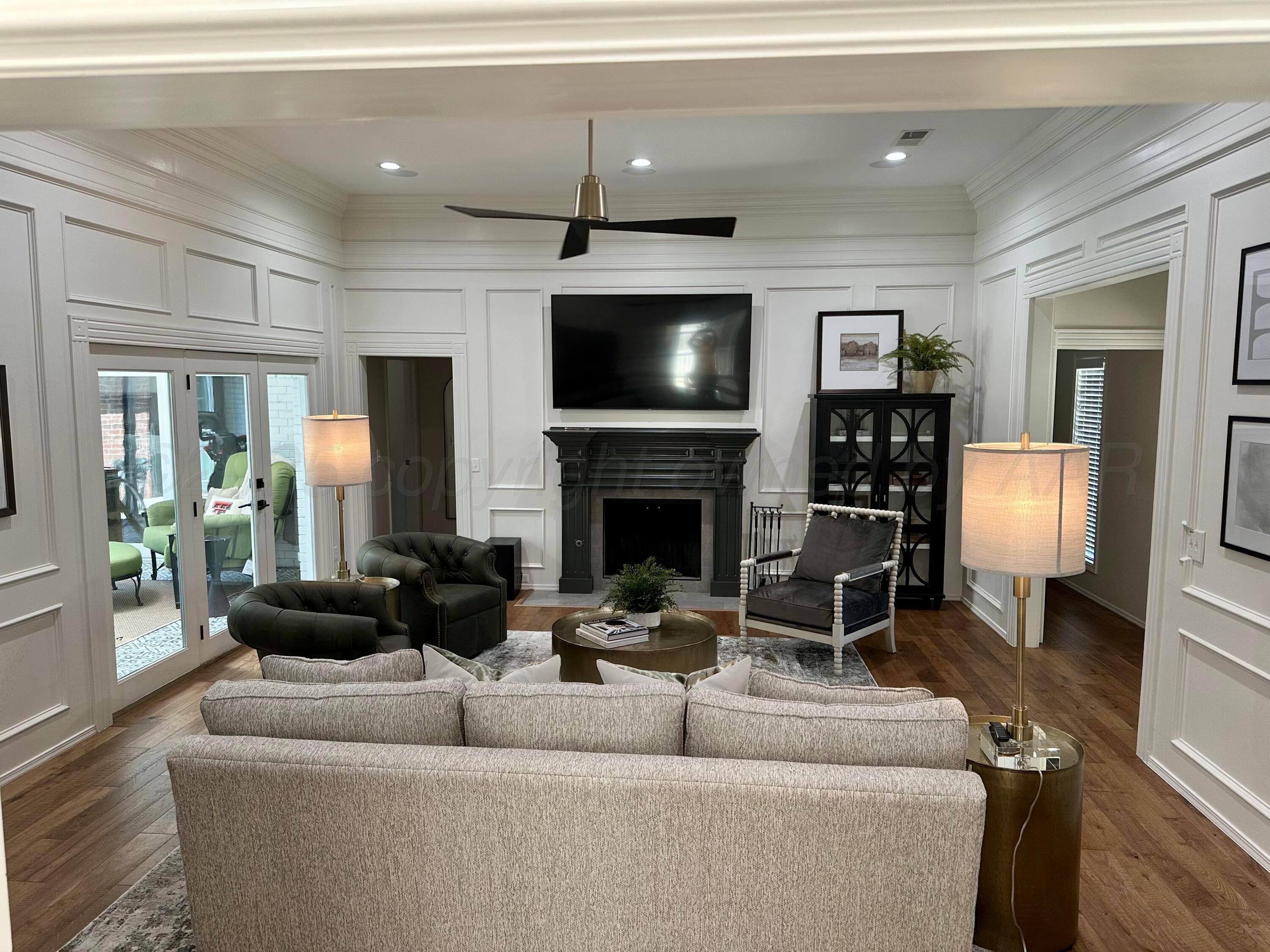 7714 Baughman Drive Amarillo, TX 79121 - Photo 5 of 37 a living room with furniture and a fireplace