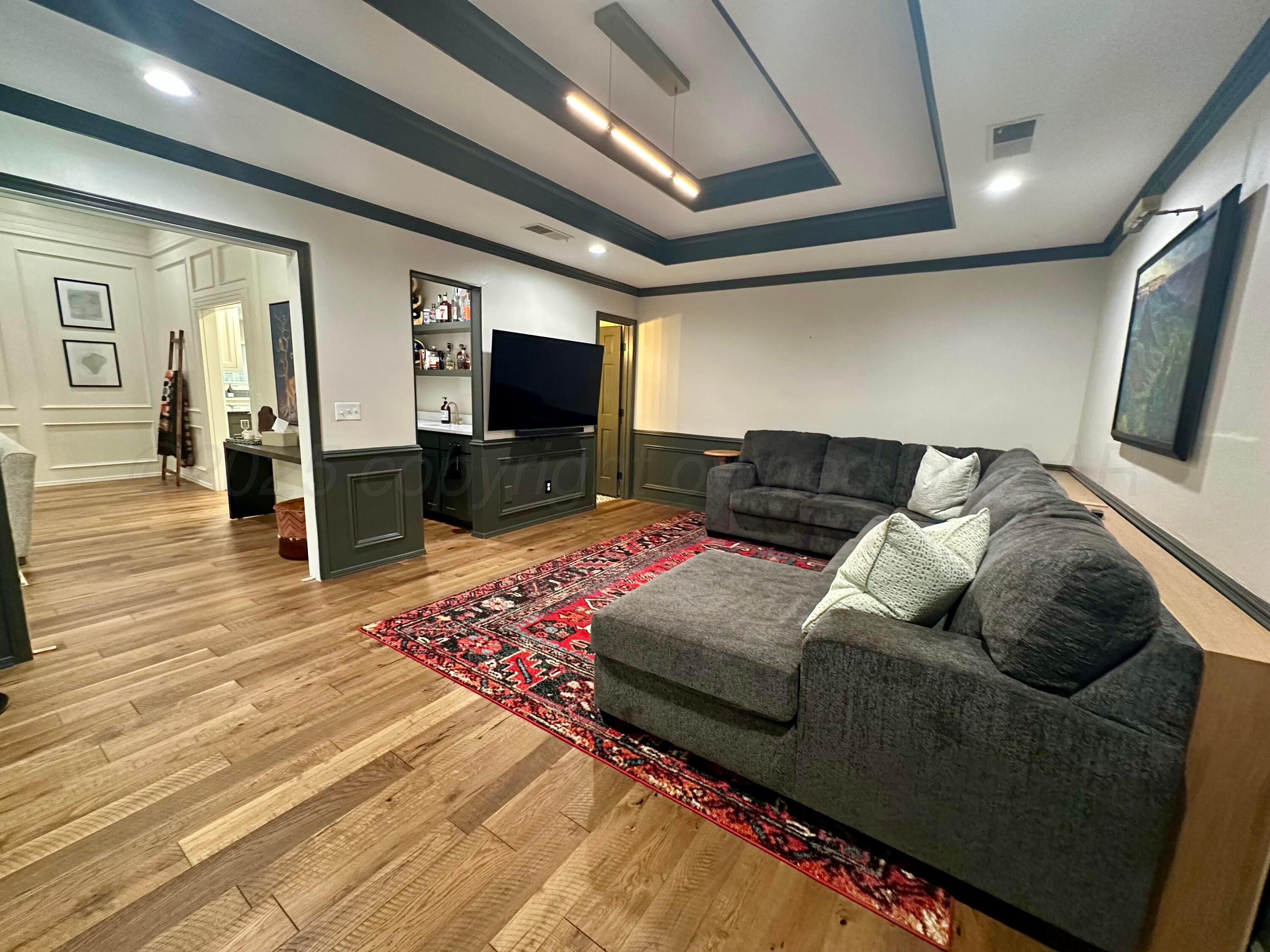7714 Baughman Drive Amarillo, TX 79121 - Photo 7 of 37 a living room with furniture and a flat screen tv
