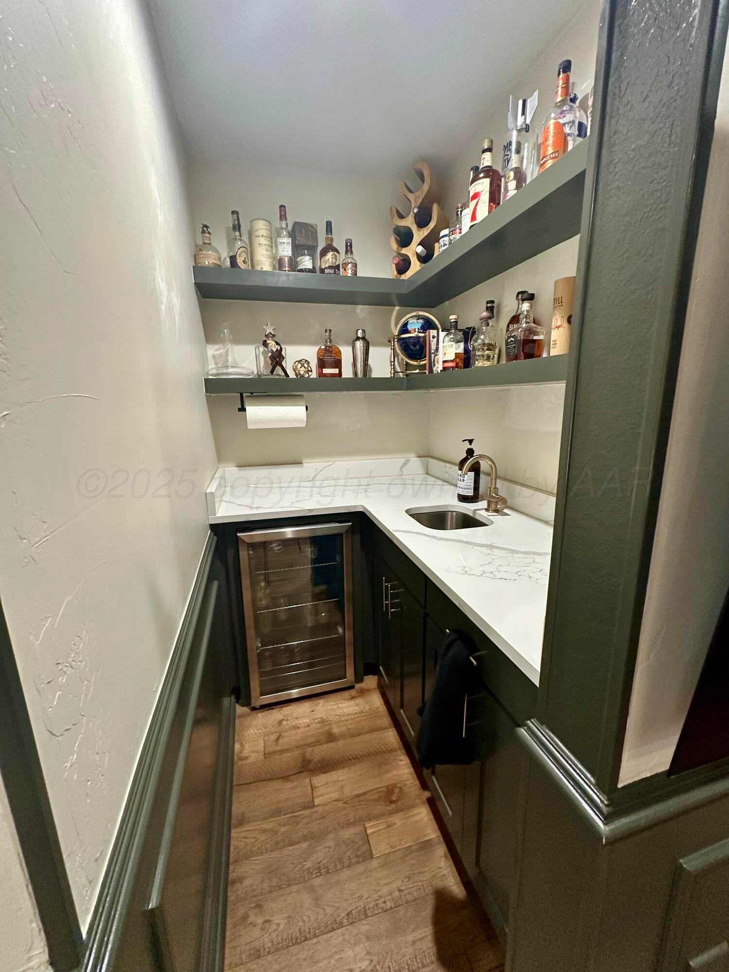 7714 Baughman Drive Amarillo, TX 79121 - Photo 8 of 37 a kitchen with stainless steel appliances granite countertop a sink and wooden cabinets