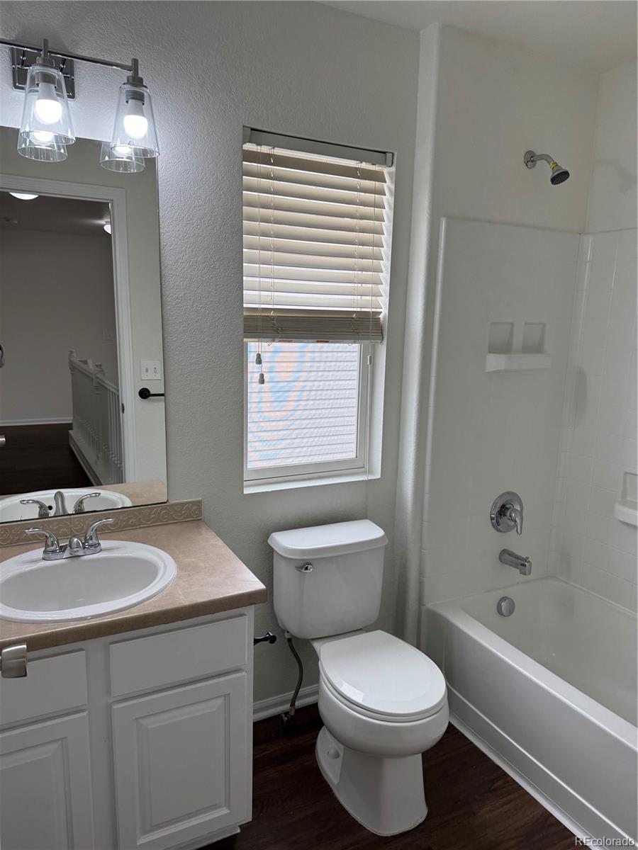 4726 Andes Street Denver, CO 80249 - Photo 13 of 17 a bathroom with a sink a toilet and shower