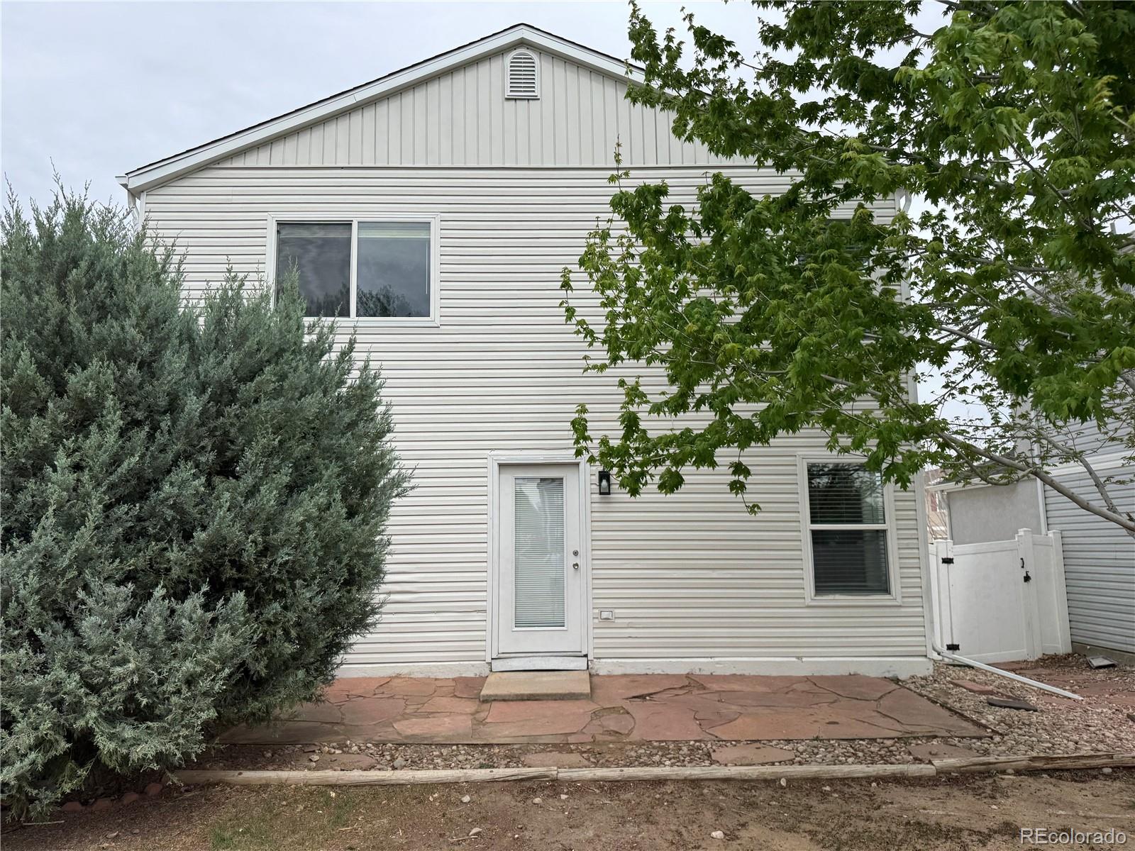 4726 Andes Street Denver, CO 80249 - Photo 14 of 17 a view of a house with a yard