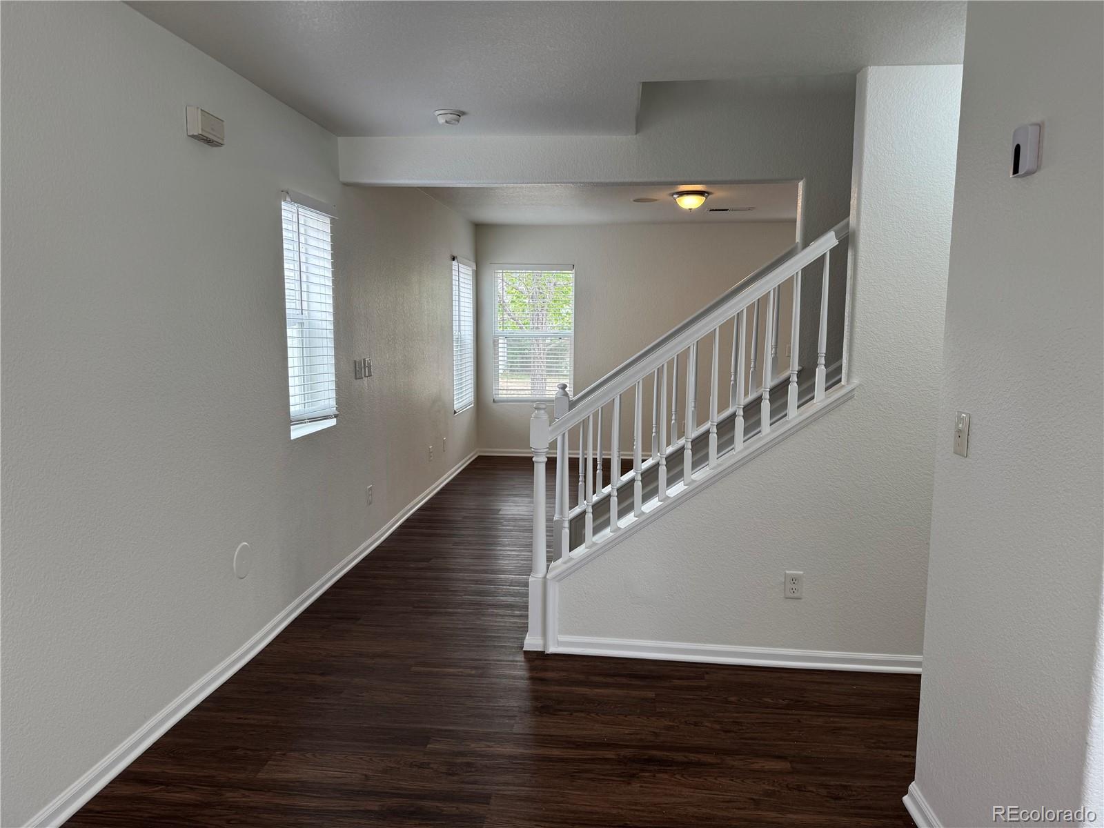 4726 Andes Street Denver, CO 80249 - Photo 3 of 17 a view of entryway and hall with wooden floor