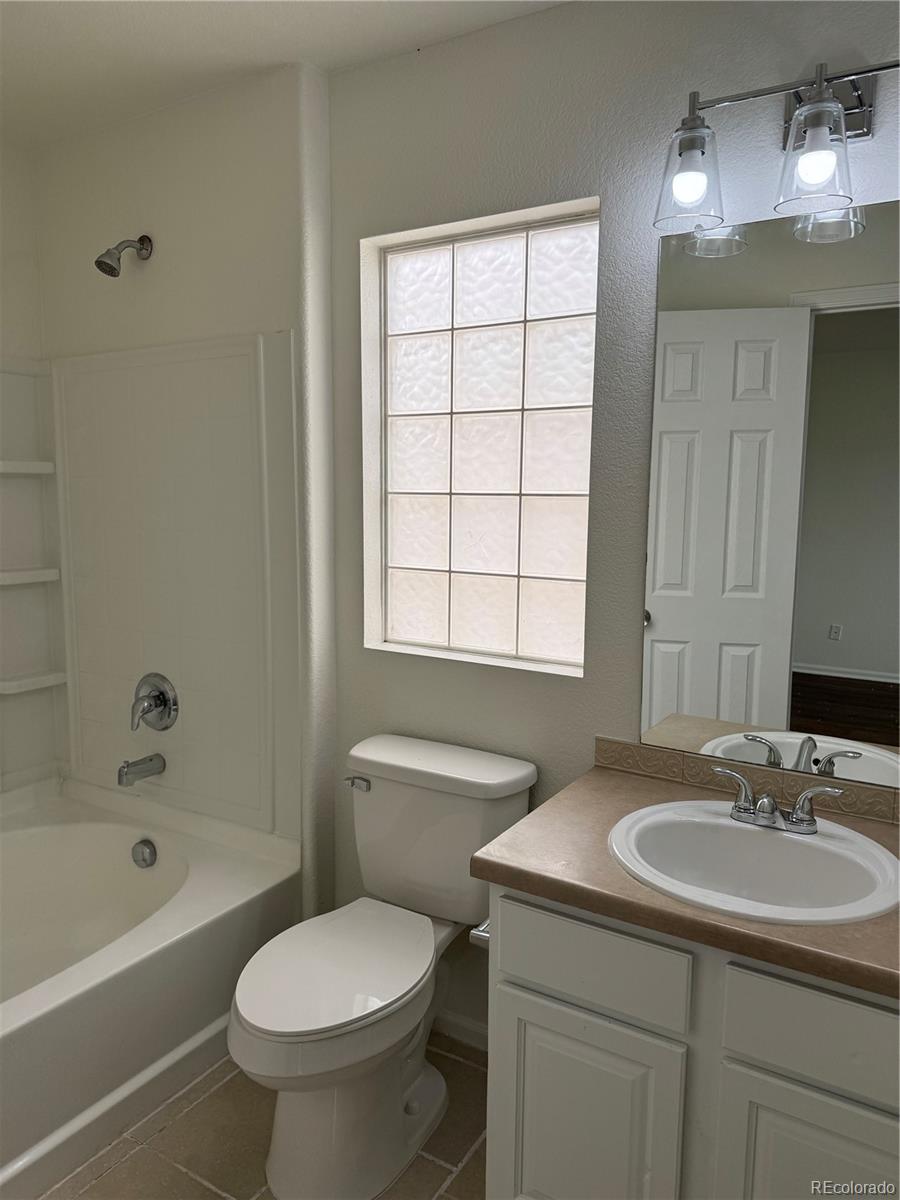 4726 Andes Street Denver, CO 80249 - Photo 10 of 17 a bathroom with a sink toilet and bathtub