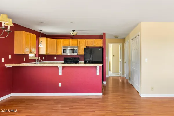 a room with wooden floors and large window