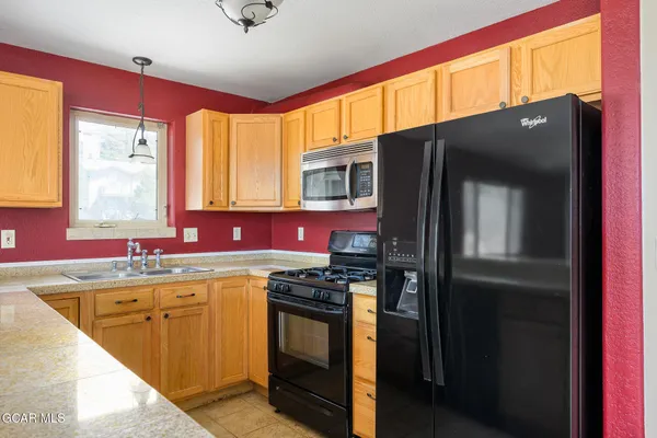 a kitchen with a sink stove and refrigerator