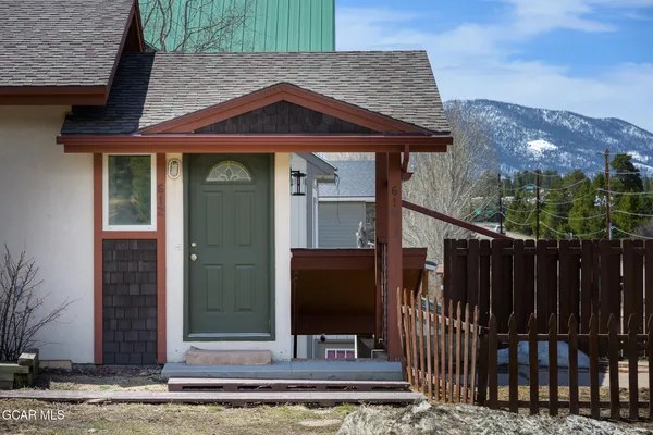 a front view of a house with glass windows and door