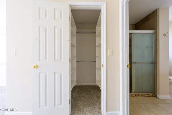 a view of a backyard with wooden fence