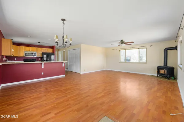 a view of a livingroom with a furniture wooden floor and windows