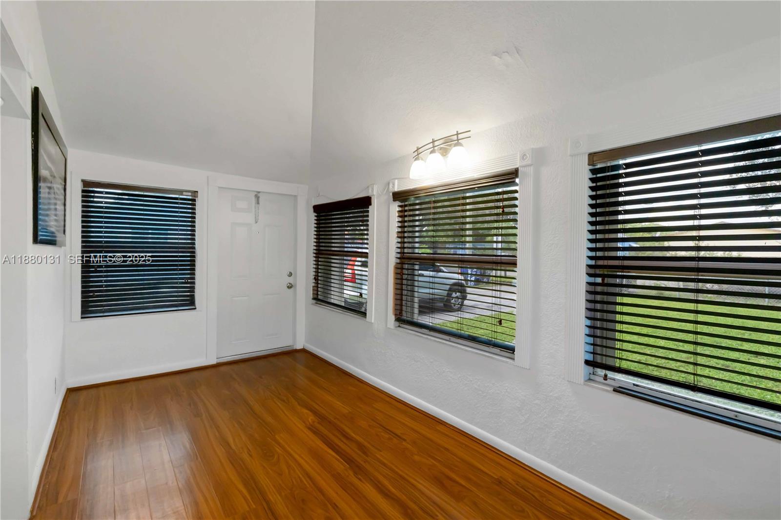 5740 Lincoln Street Hollywood, FL 33021 - Photo 11 of 28 a view of an empty room with glass door and wooden floor