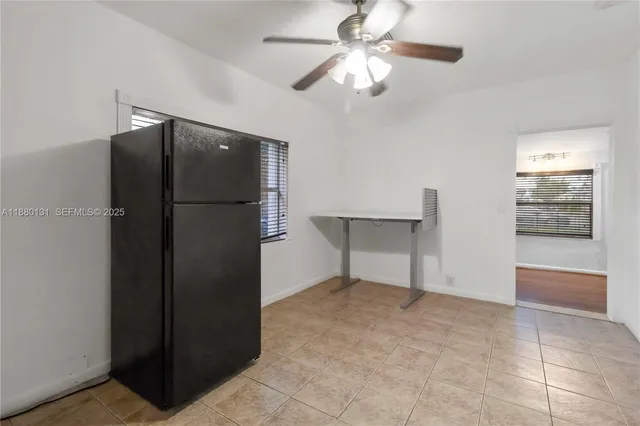 an empty room with closet and windows